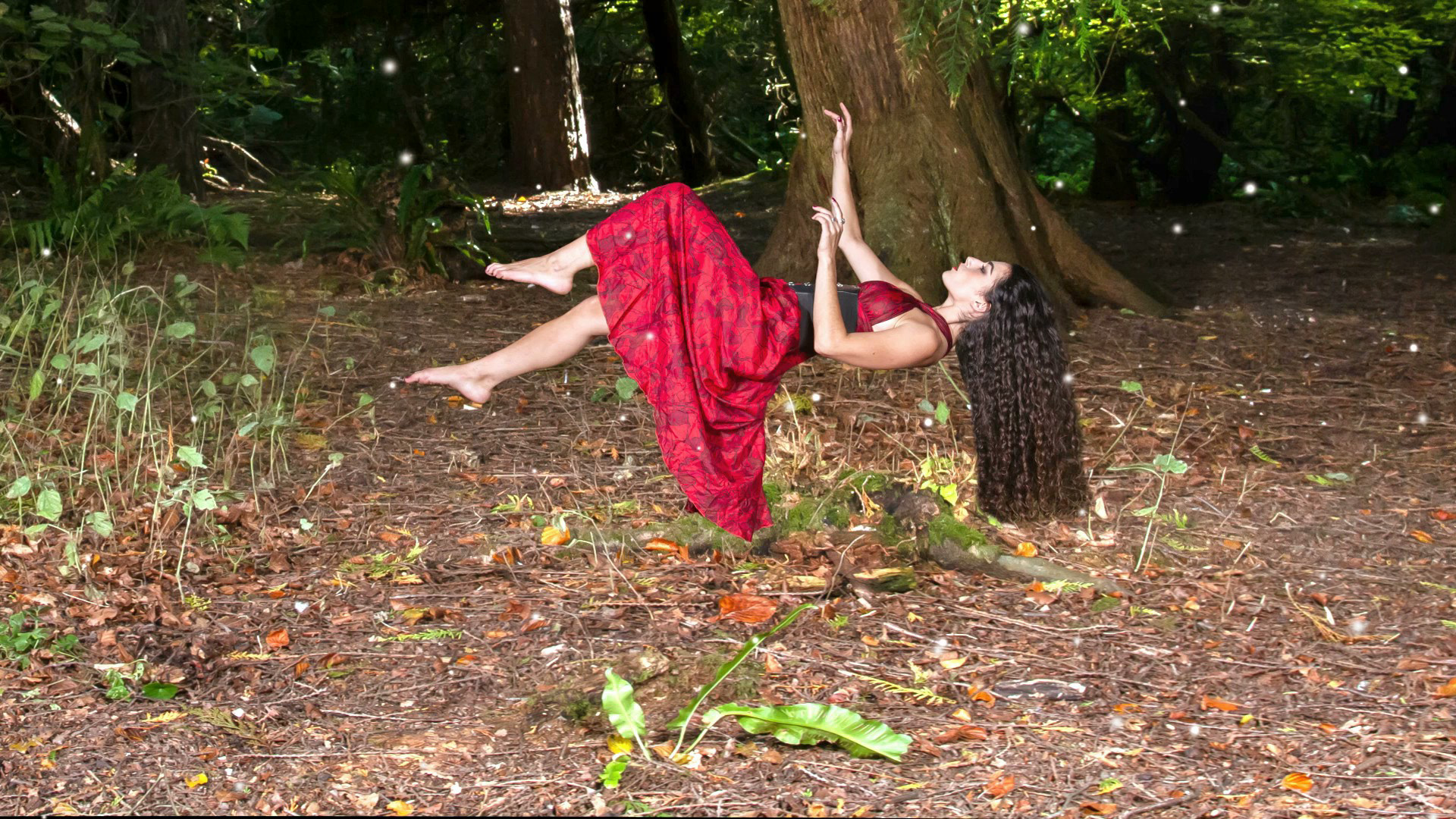 Model levitating in a forest