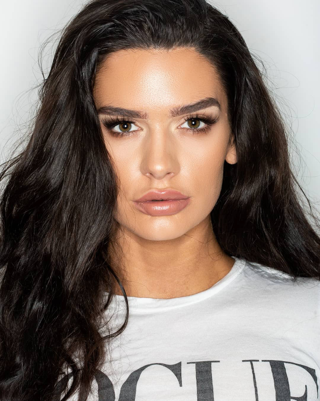 Brunette model wearing a Vogue t-shirt