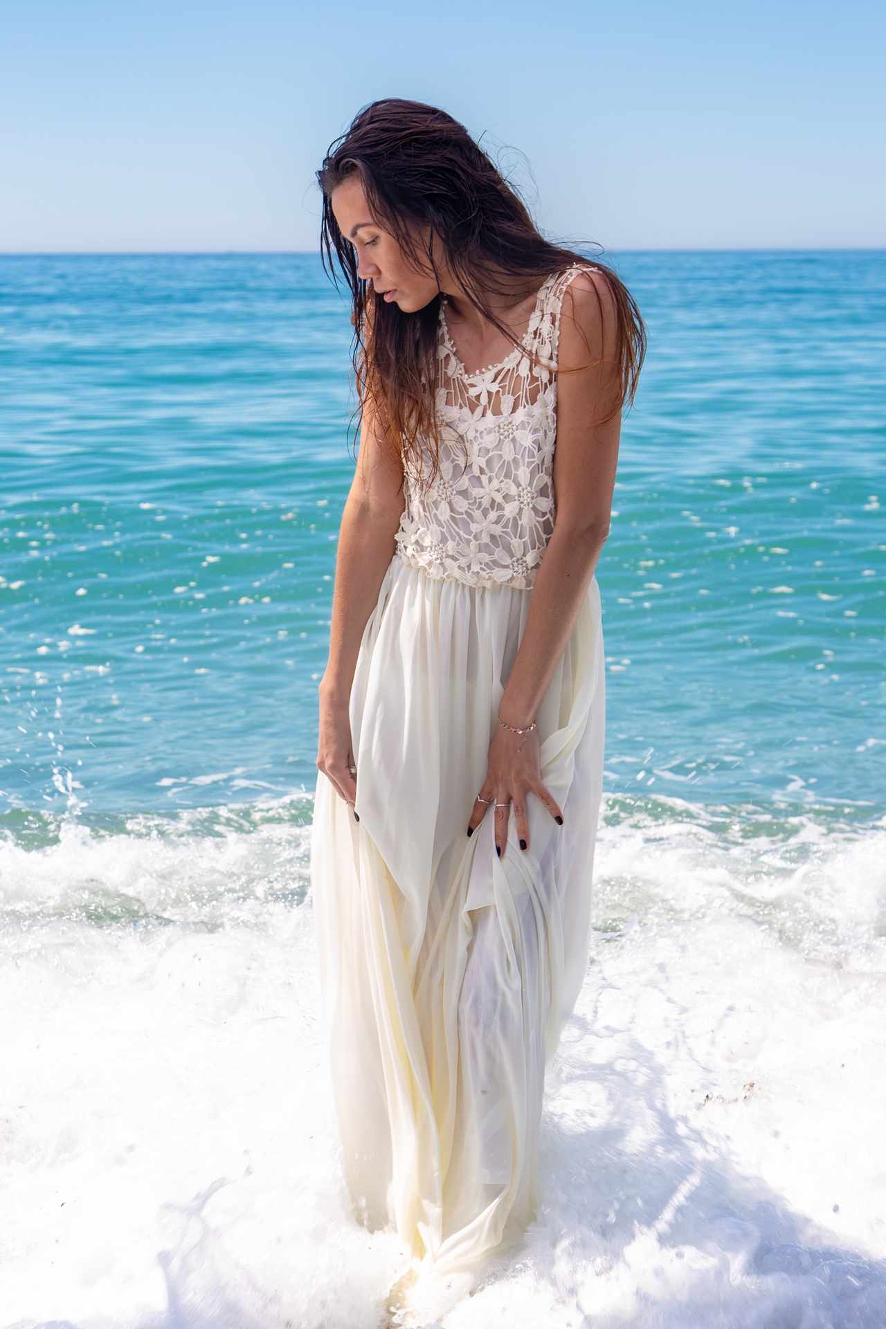 Asian model wearing a white dress in the sea