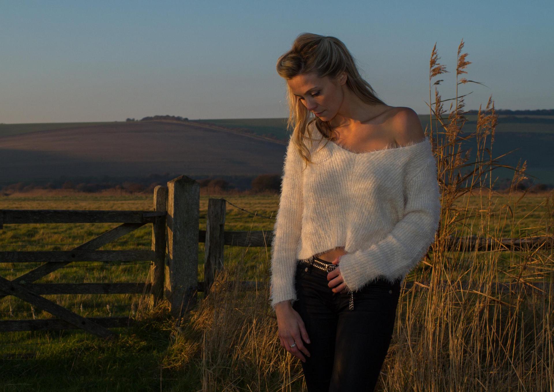 Rebecca Poole AKA Purdy in a field at sunset